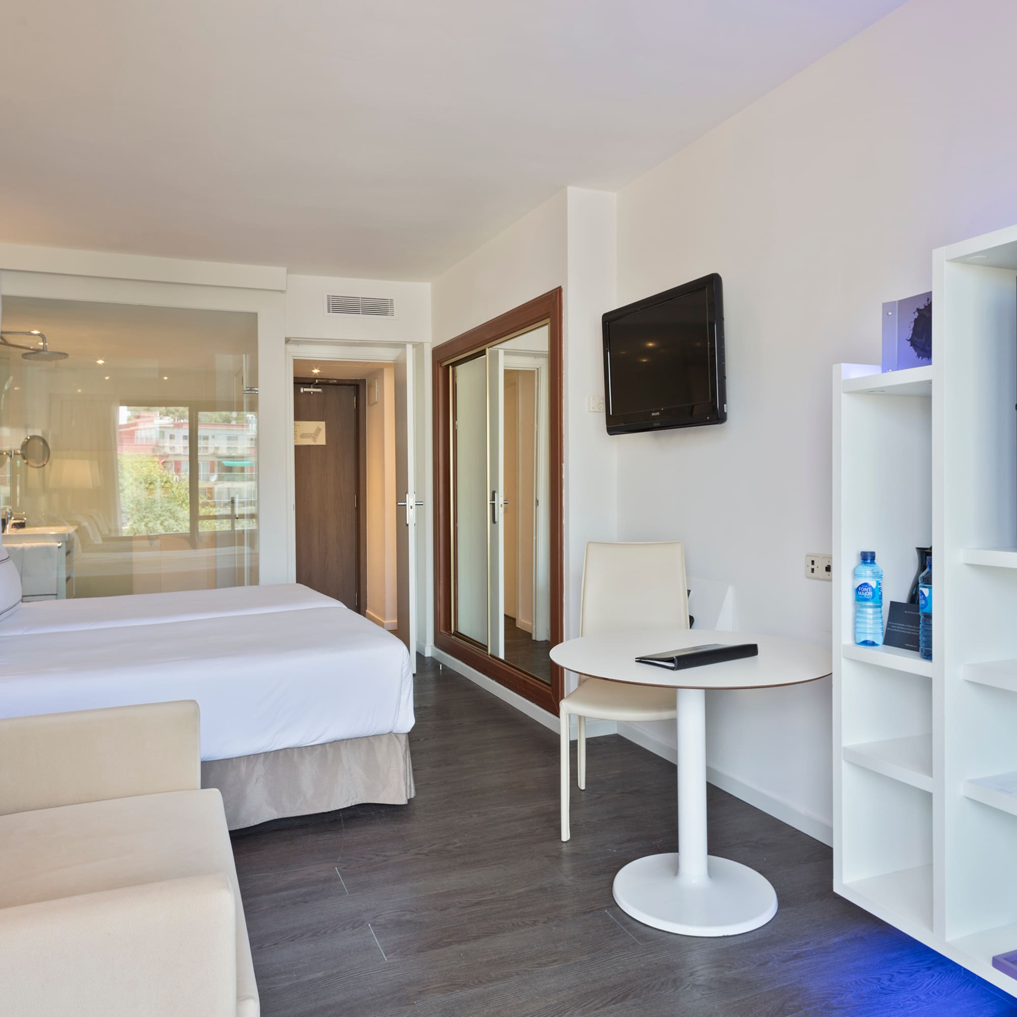 a room with a bed and a tv