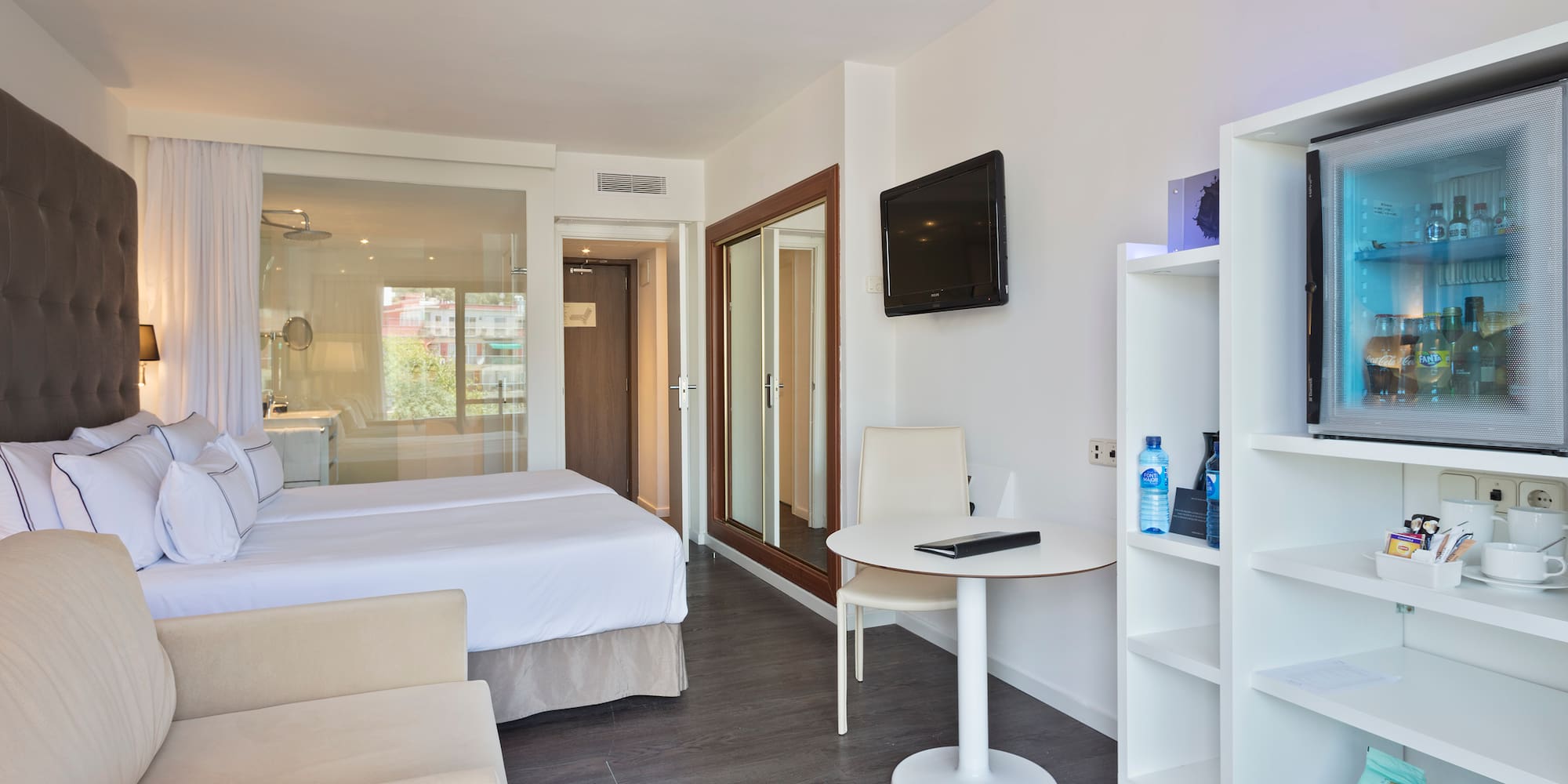 a room with a bed and a tv