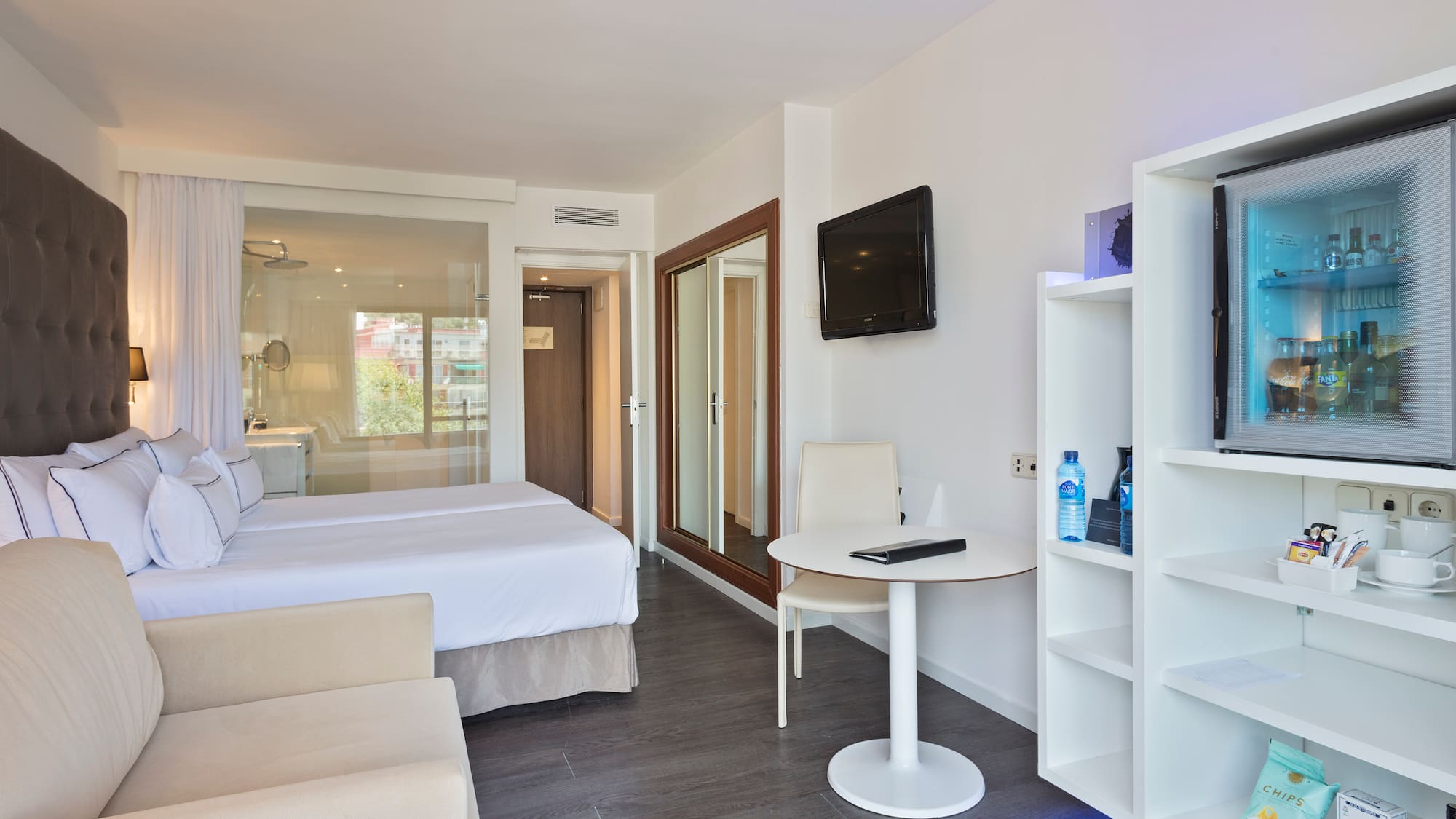 a room with a bed and a tv