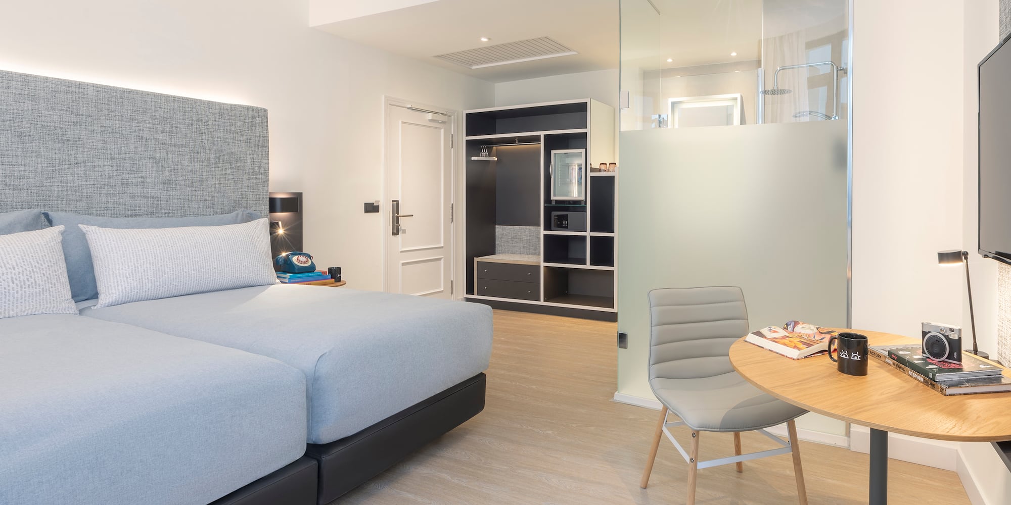 a bedroom with a glass partition