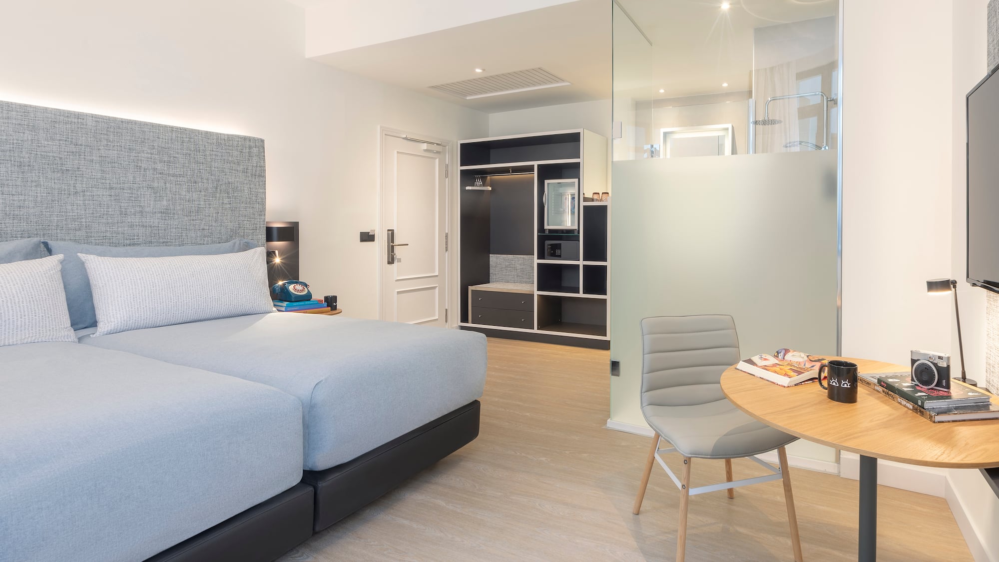 a bedroom with a glass partition