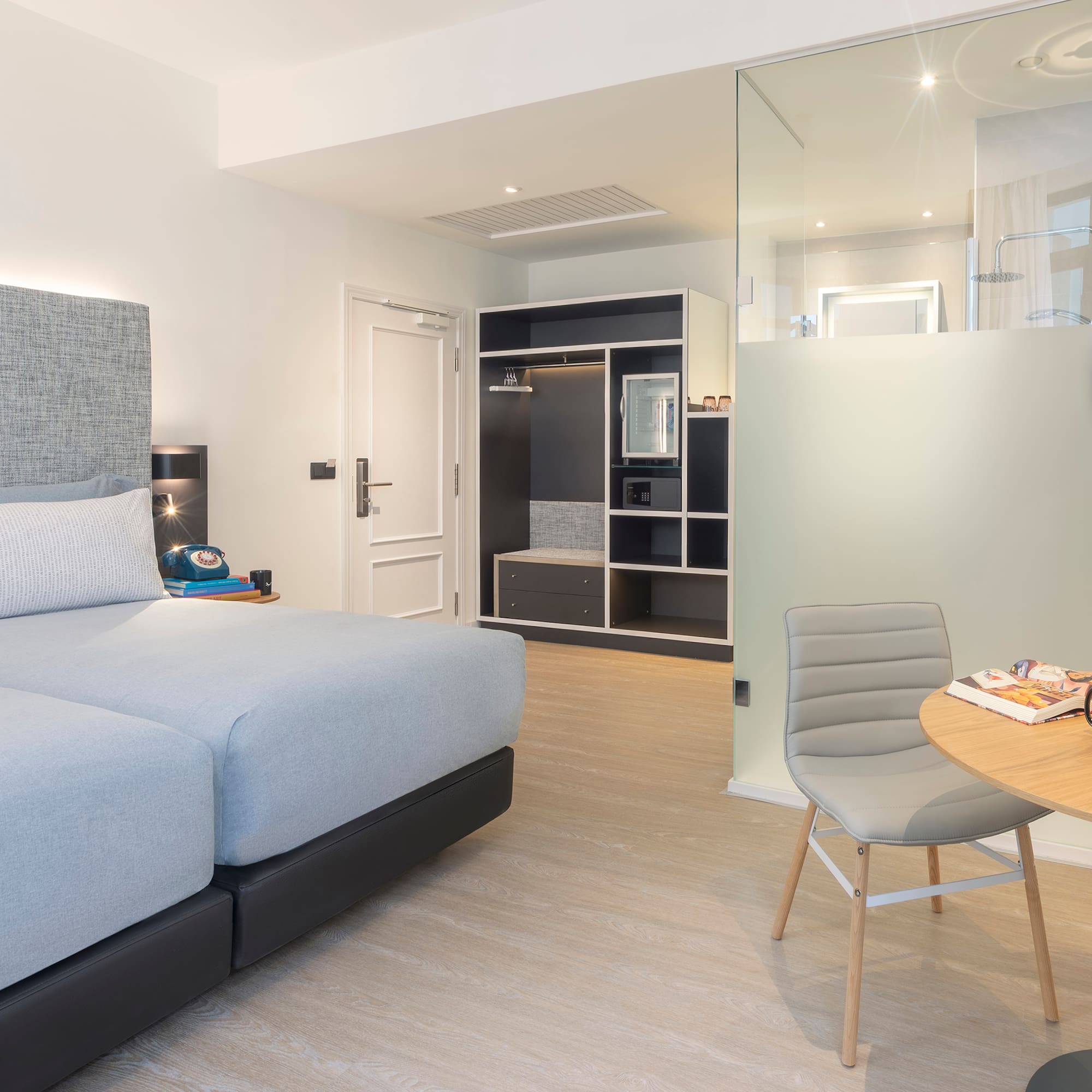 a bedroom with a glass partition