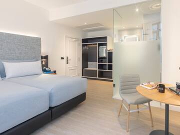 a bedroom with a glass partition