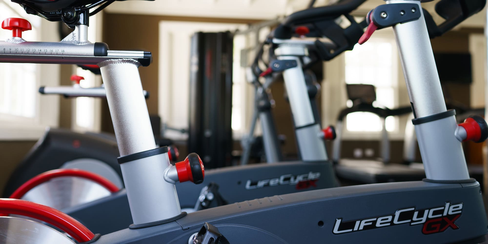 a group of exercise bikes in a gym