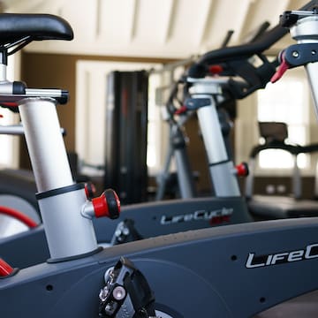 a group of exercise bikes in a gym