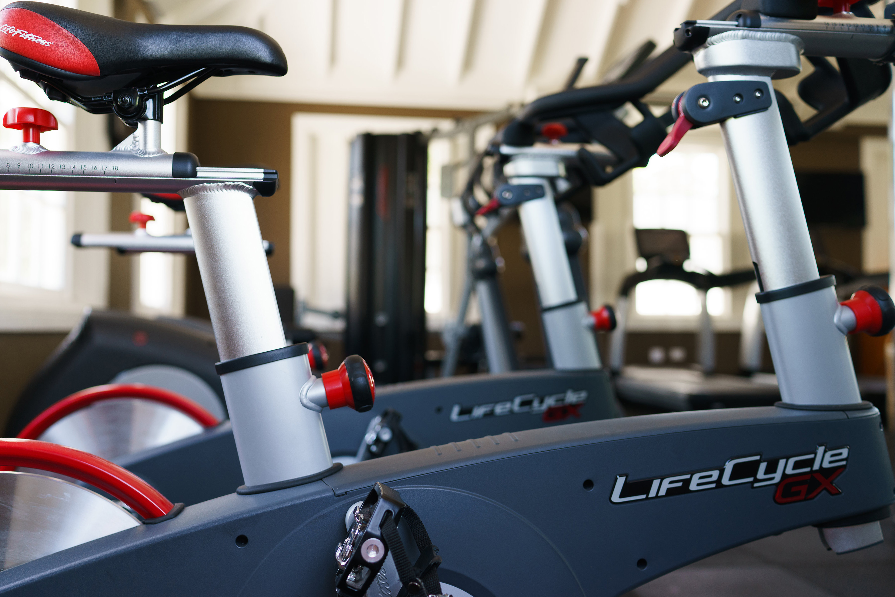 a group of exercise bikes in a gym