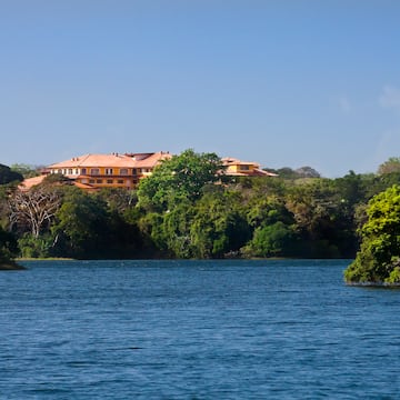 a house on the hill by a body of water