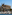 a castle with many boats in the water with Palma Cathedral in the background