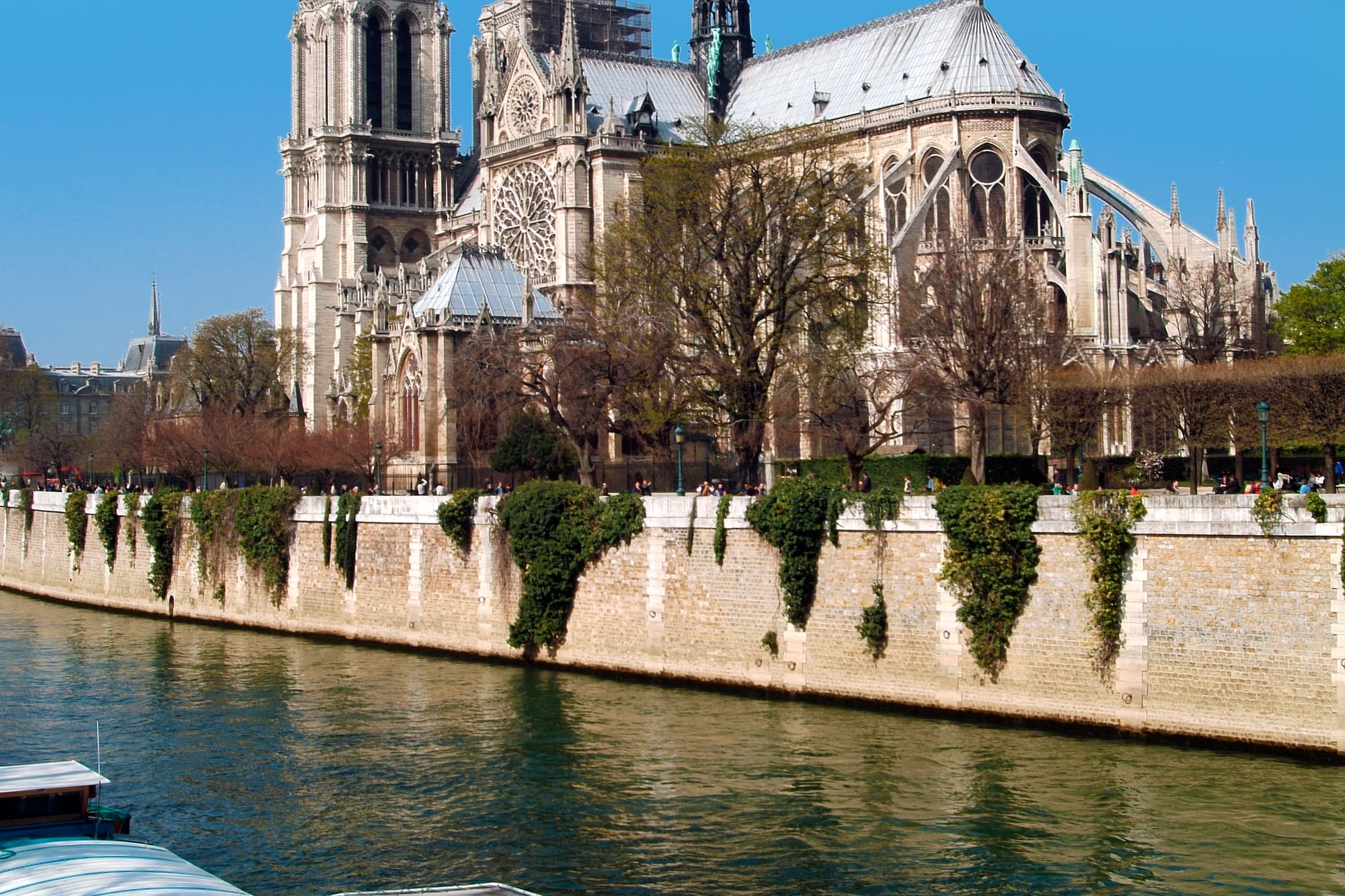 a river with boats on it and a building with a spire