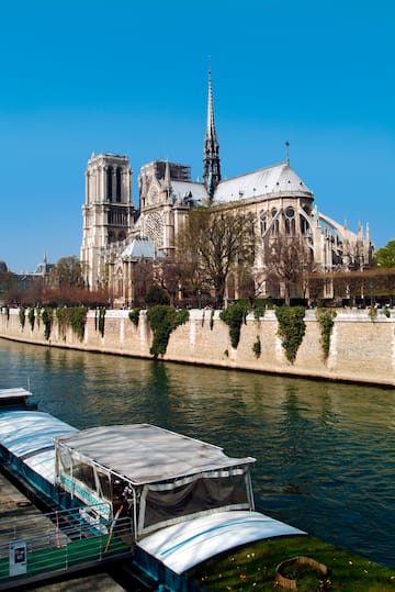 a river with boats on it and a building with a spire