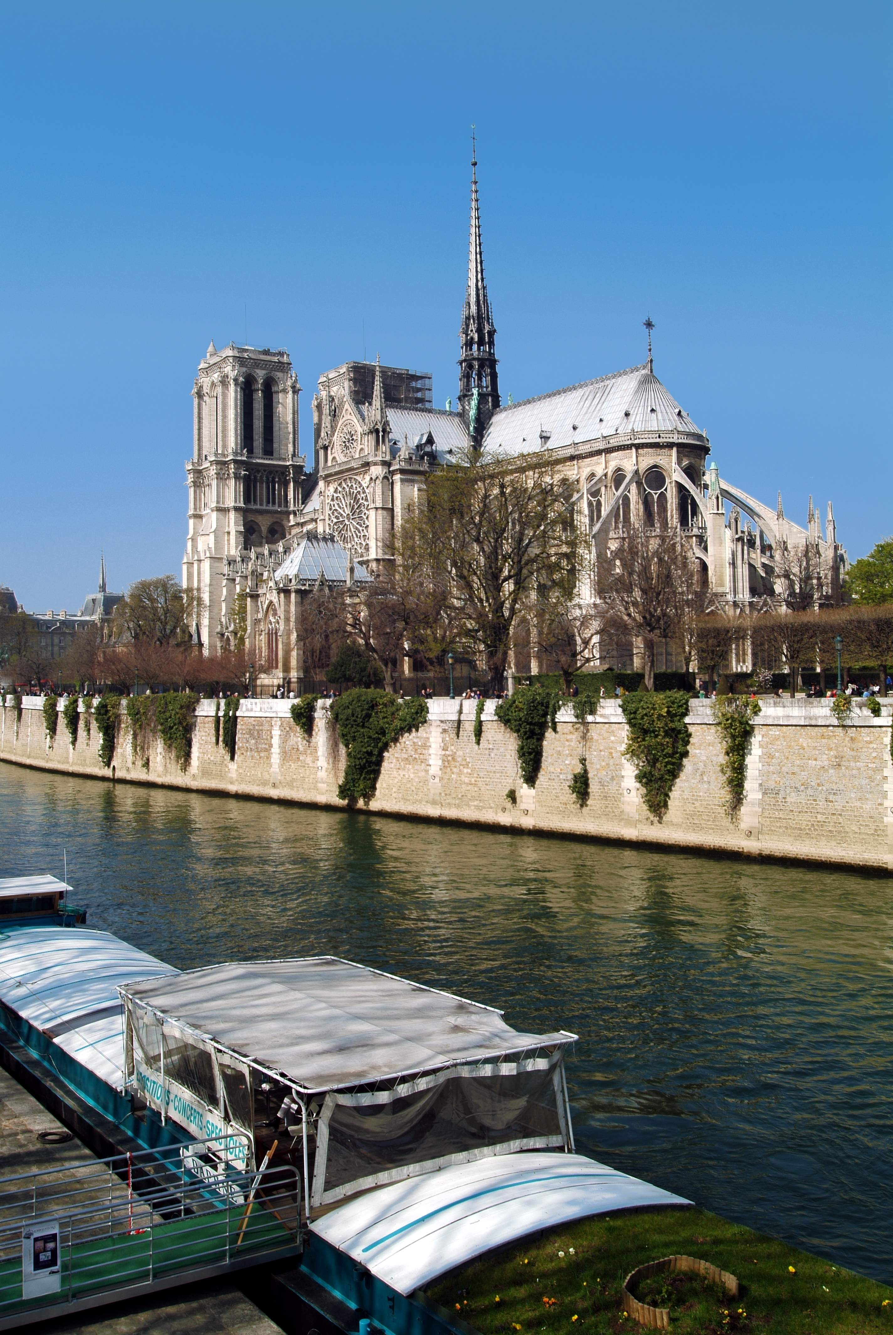 a river with boats on it and a building with a spire