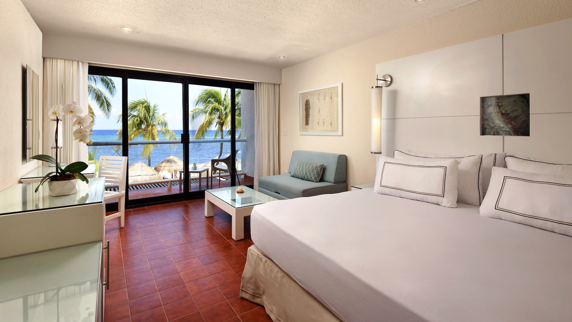 a room with a bed and a couch and chairs