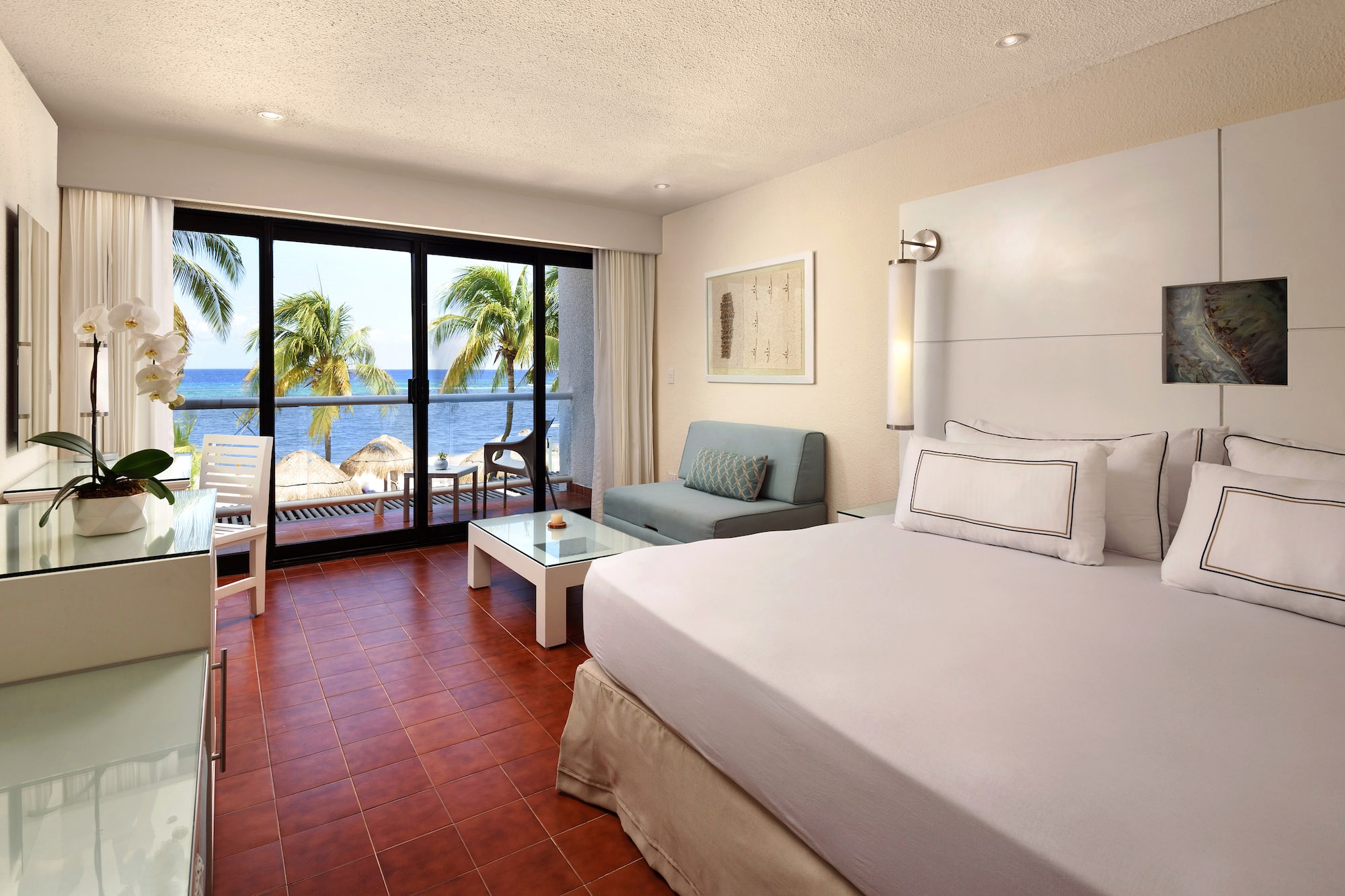 a room with a bed and a couch and chairs