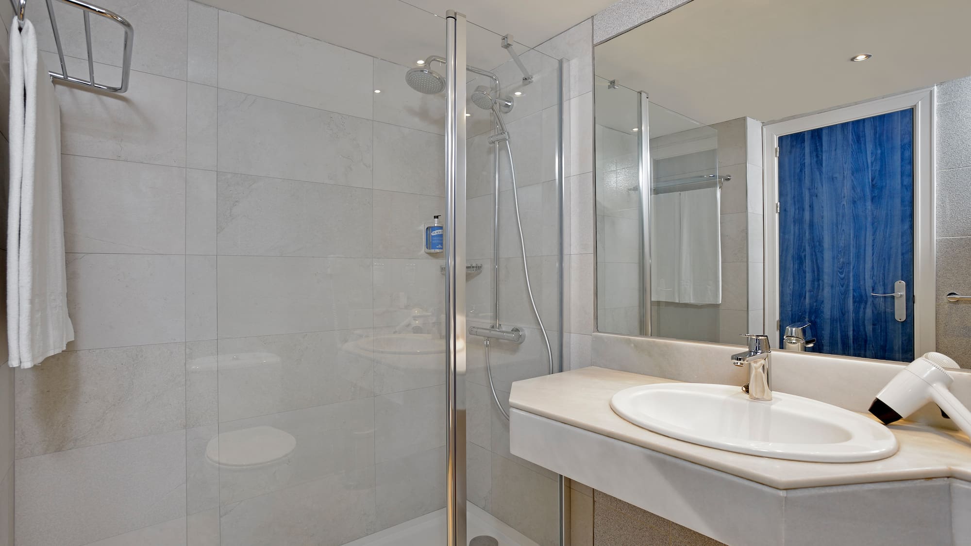 a bathroom with a shower and sink