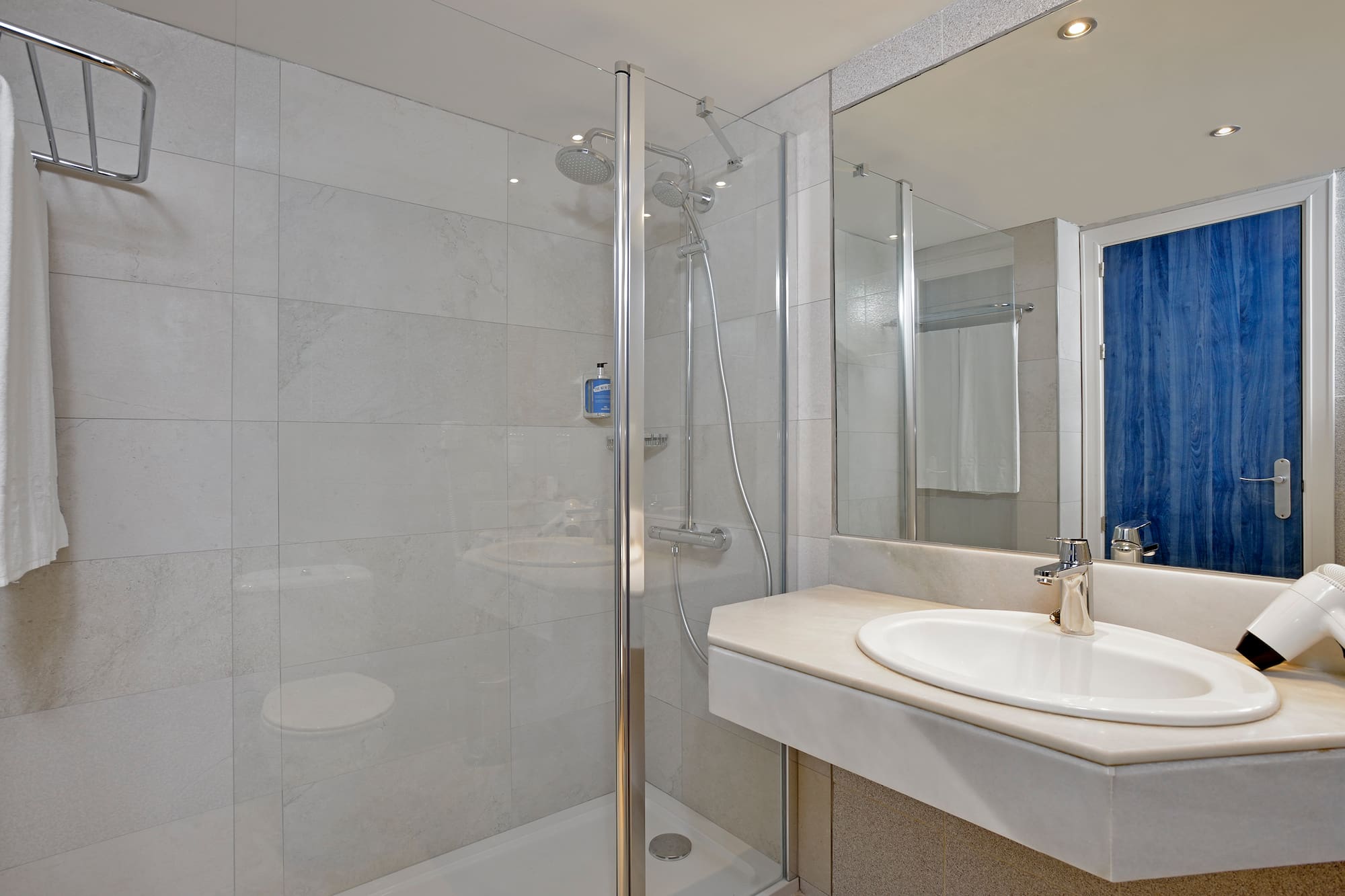 a bathroom with a shower and sink