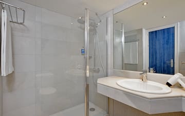 a bathroom with a shower and sink