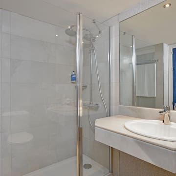 a bathroom with a shower and sink