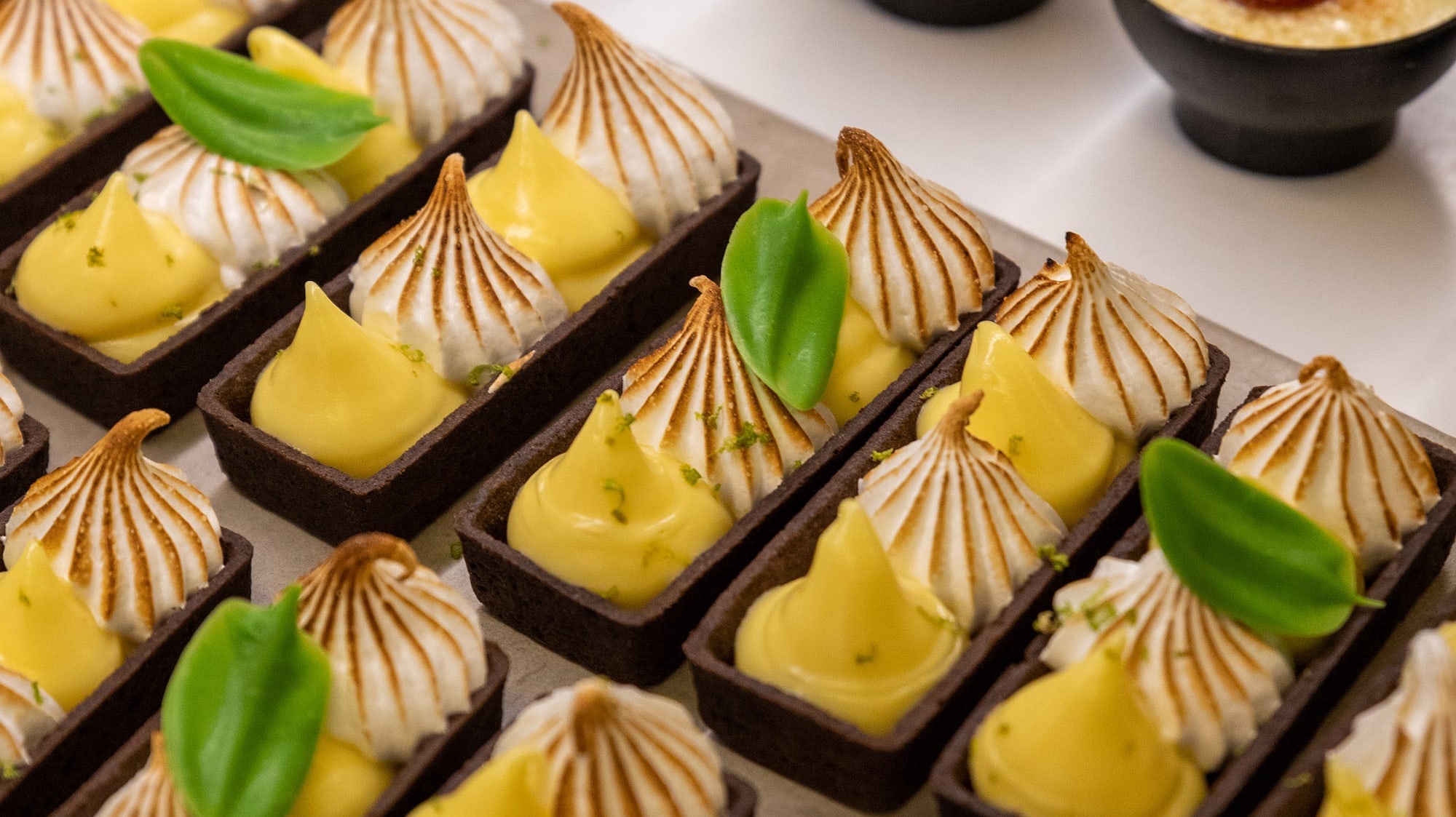 a tray of desserts with different toppings