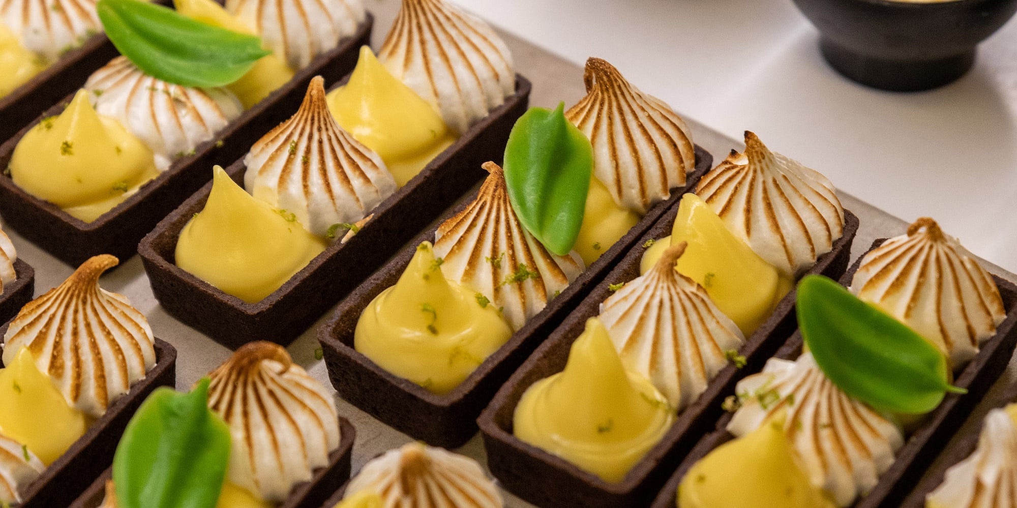 a tray of desserts with different toppings