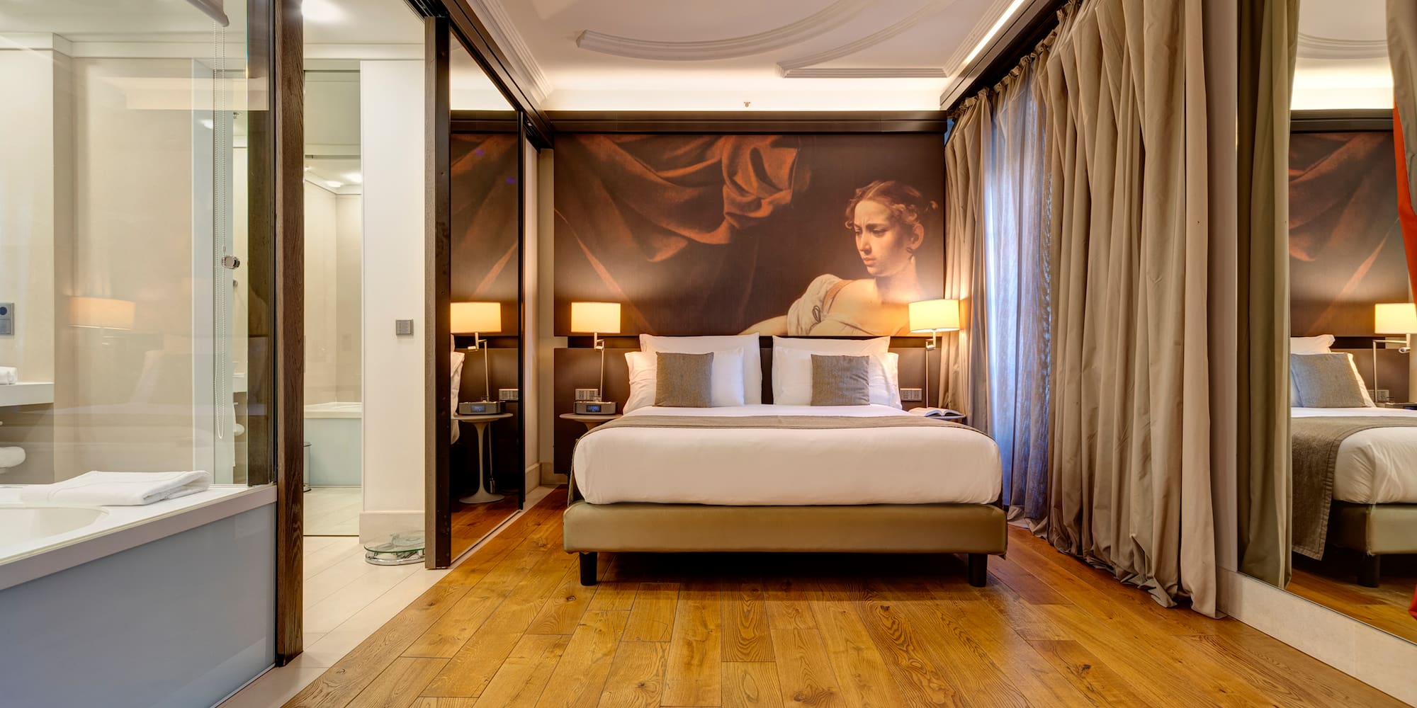 a bedroom with a large painting on the wall