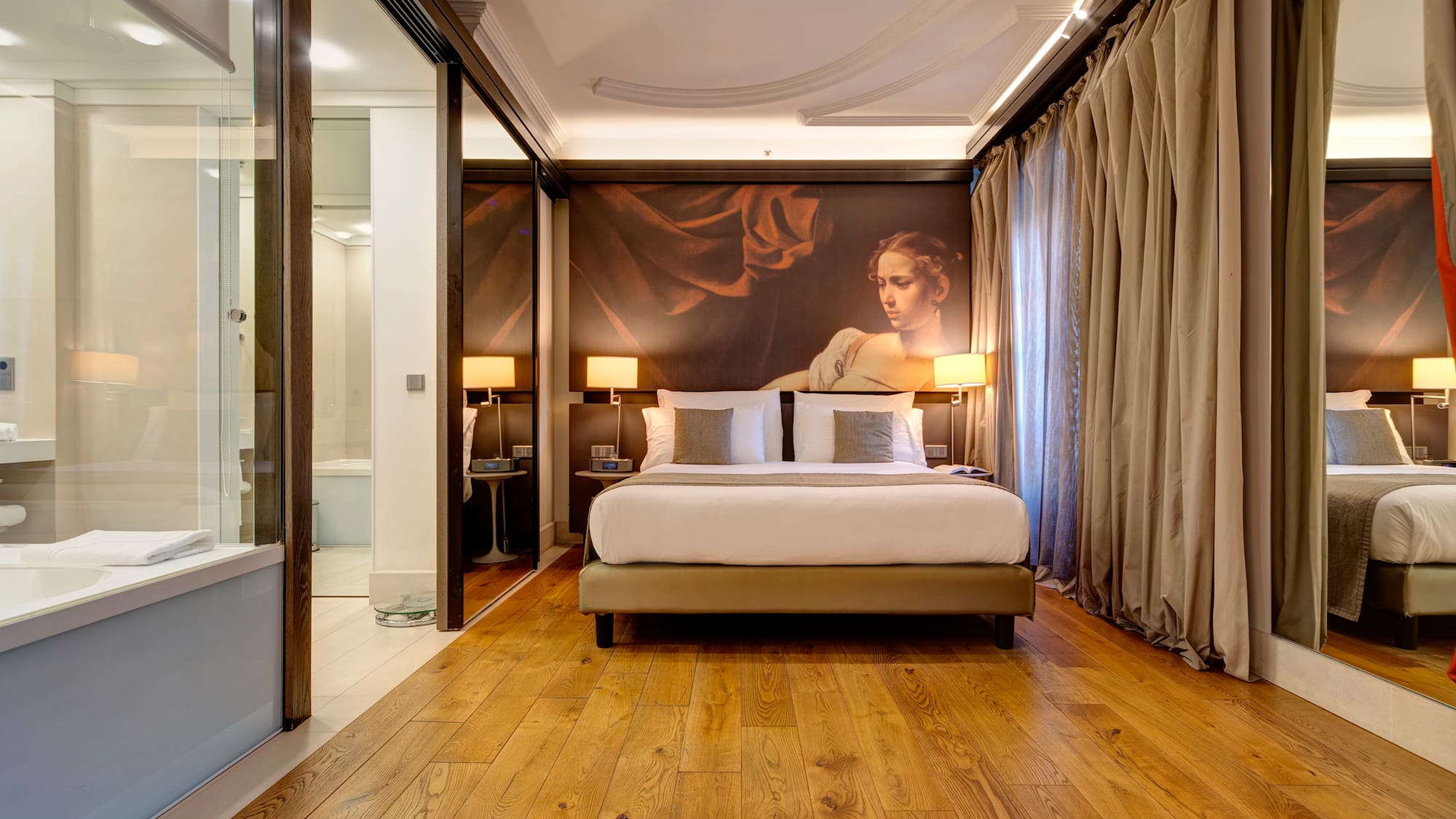 a bedroom with a large painting on the wall