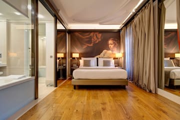 a bedroom with a large painting on the wall