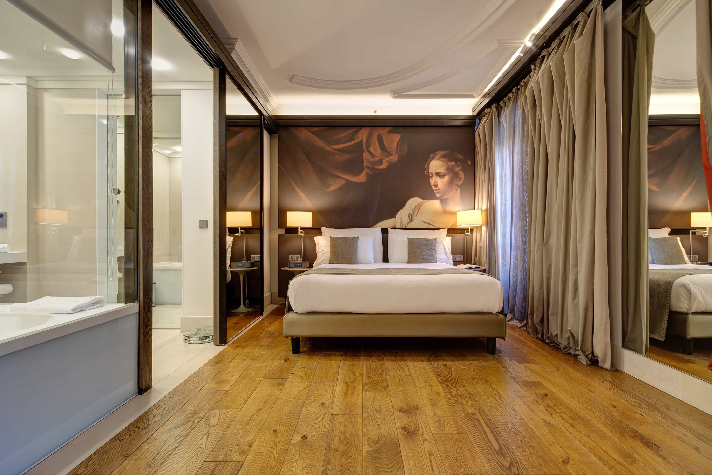 a bedroom with a large painting on the wall
