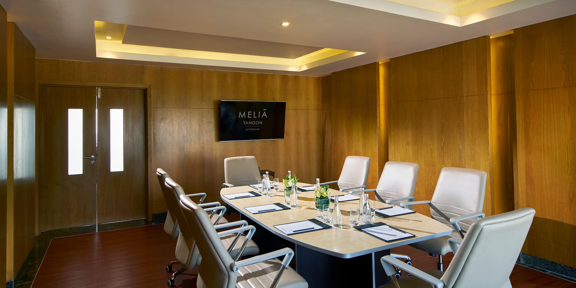 a conference room with a table and chairs