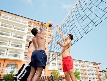 a group of men playing volleyball
