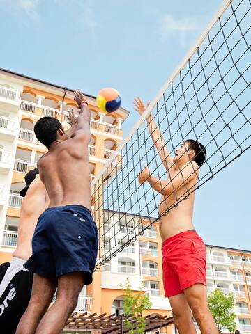 a group of men playing volleyball