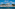 Nikki Beach resort hotel on a sunny beach, modern buildings, blue sea.
