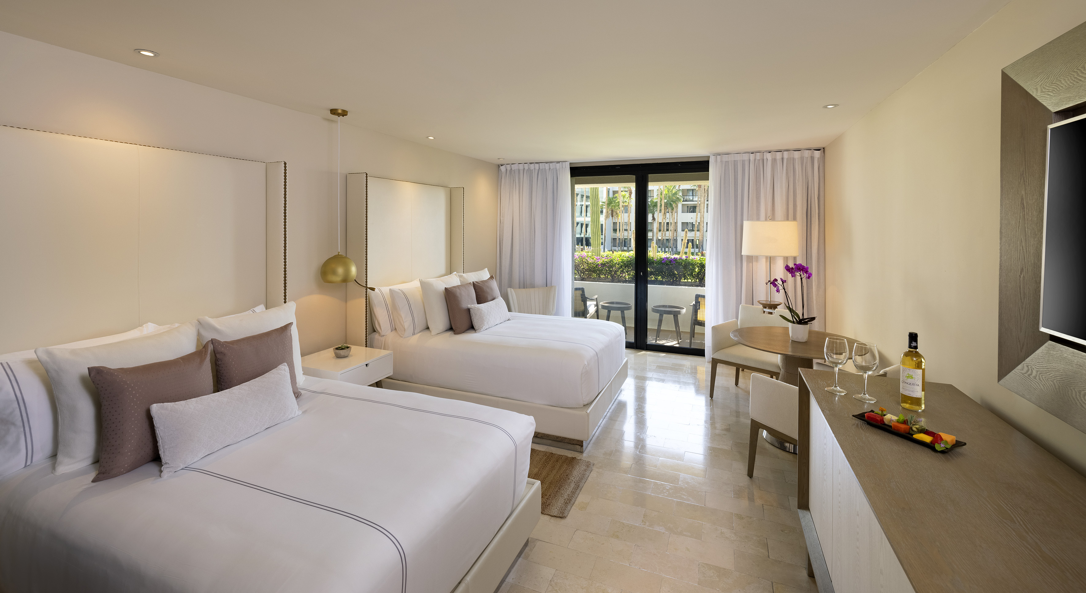 a room with two beds and a table