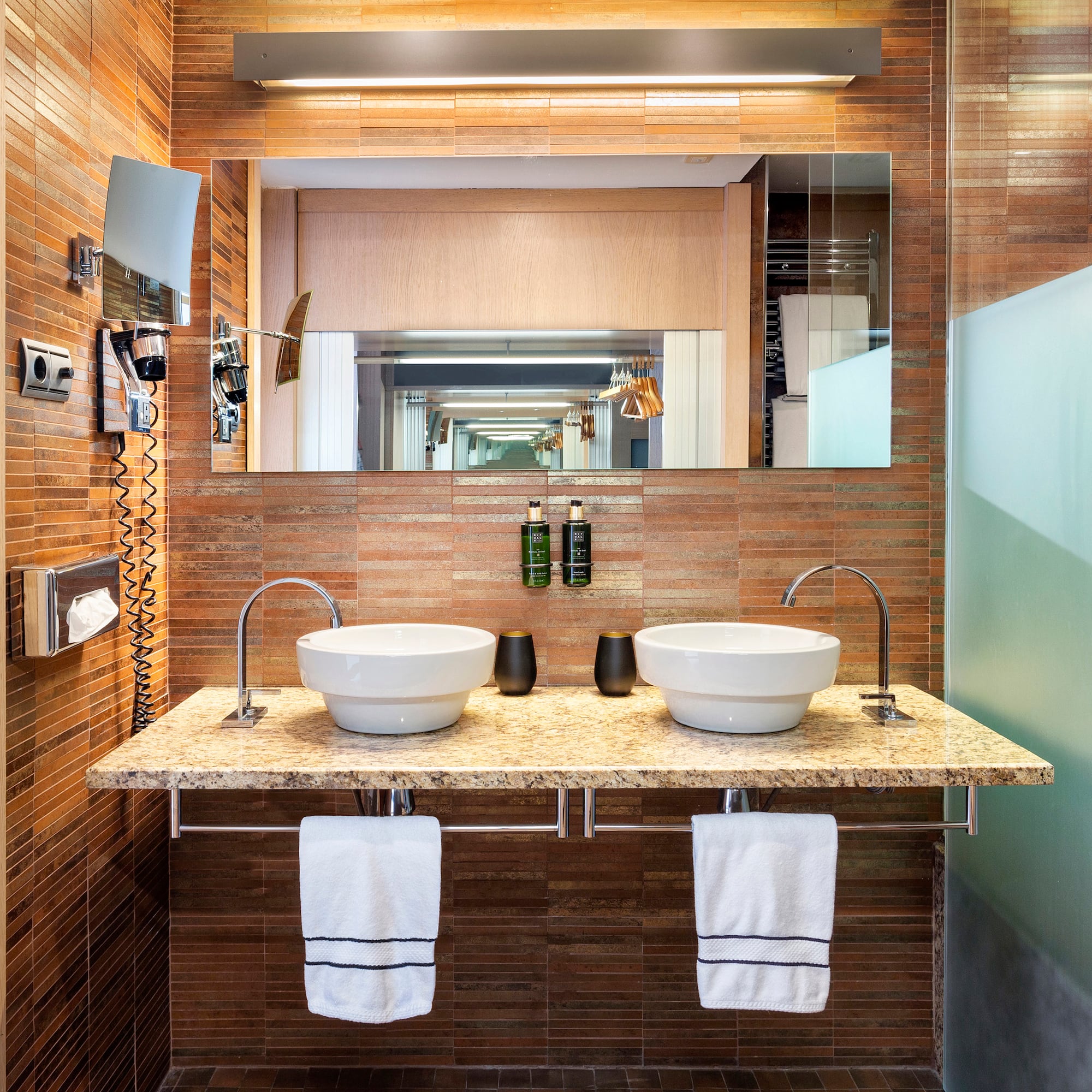 a bathroom with two sinks and a mirror