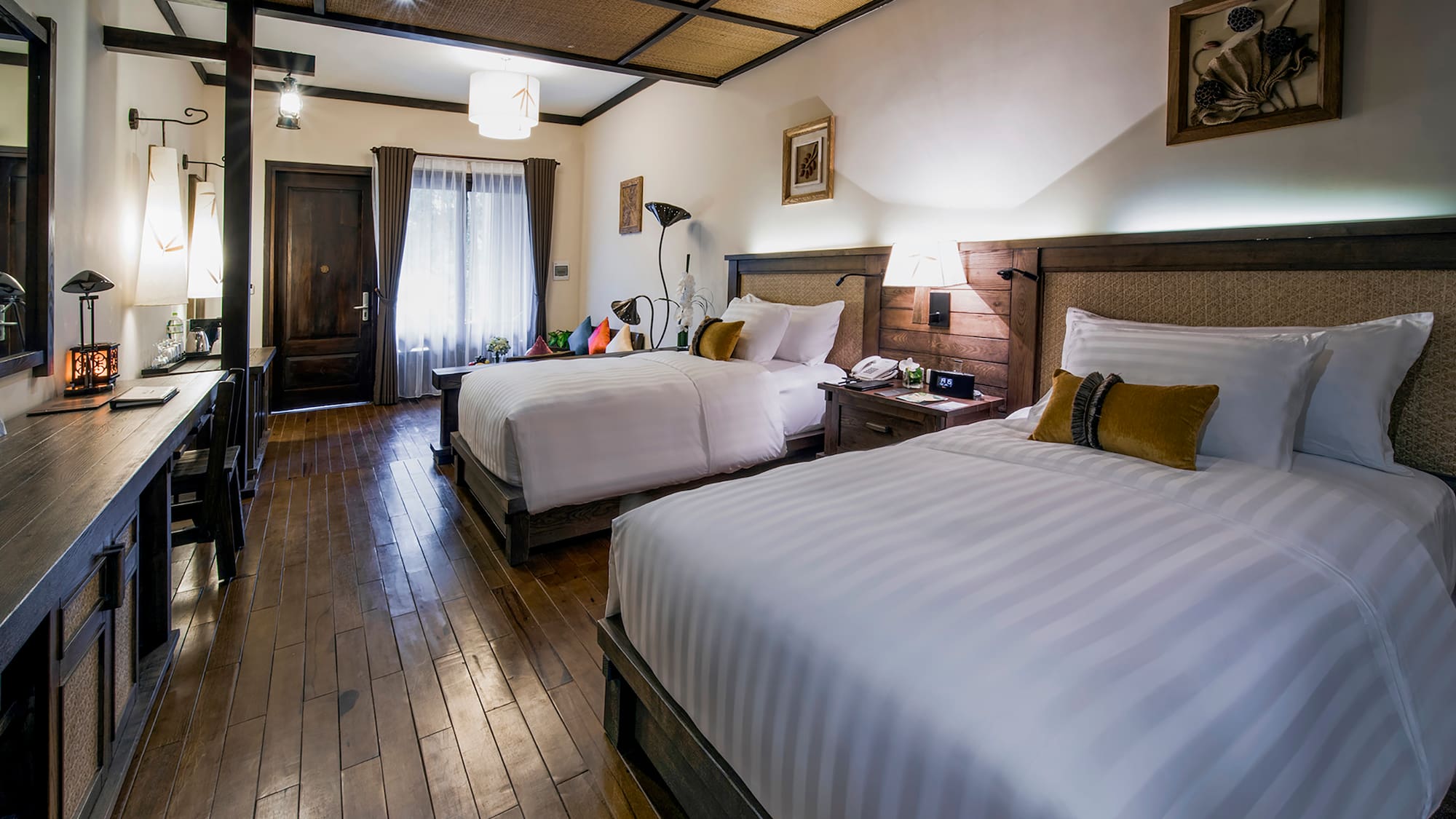 a room with two beds and a wood floor