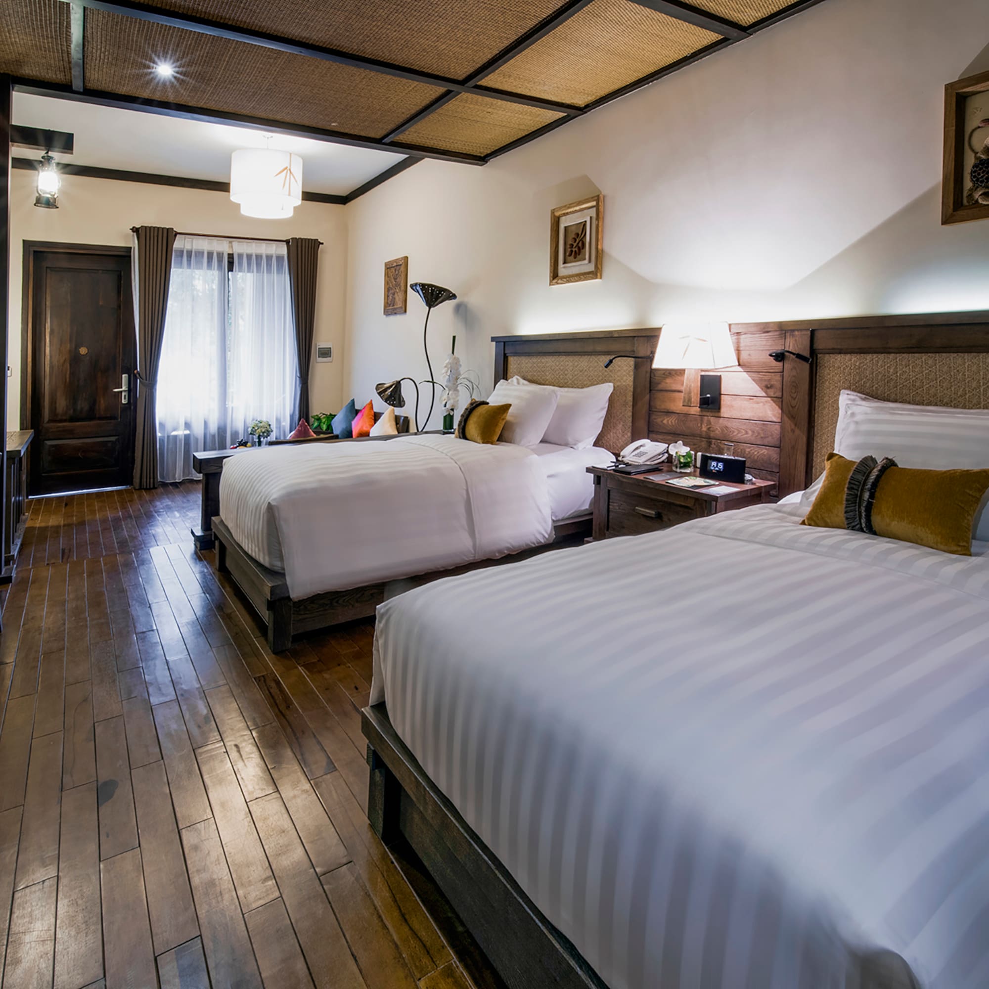 a room with two beds and a wood floor