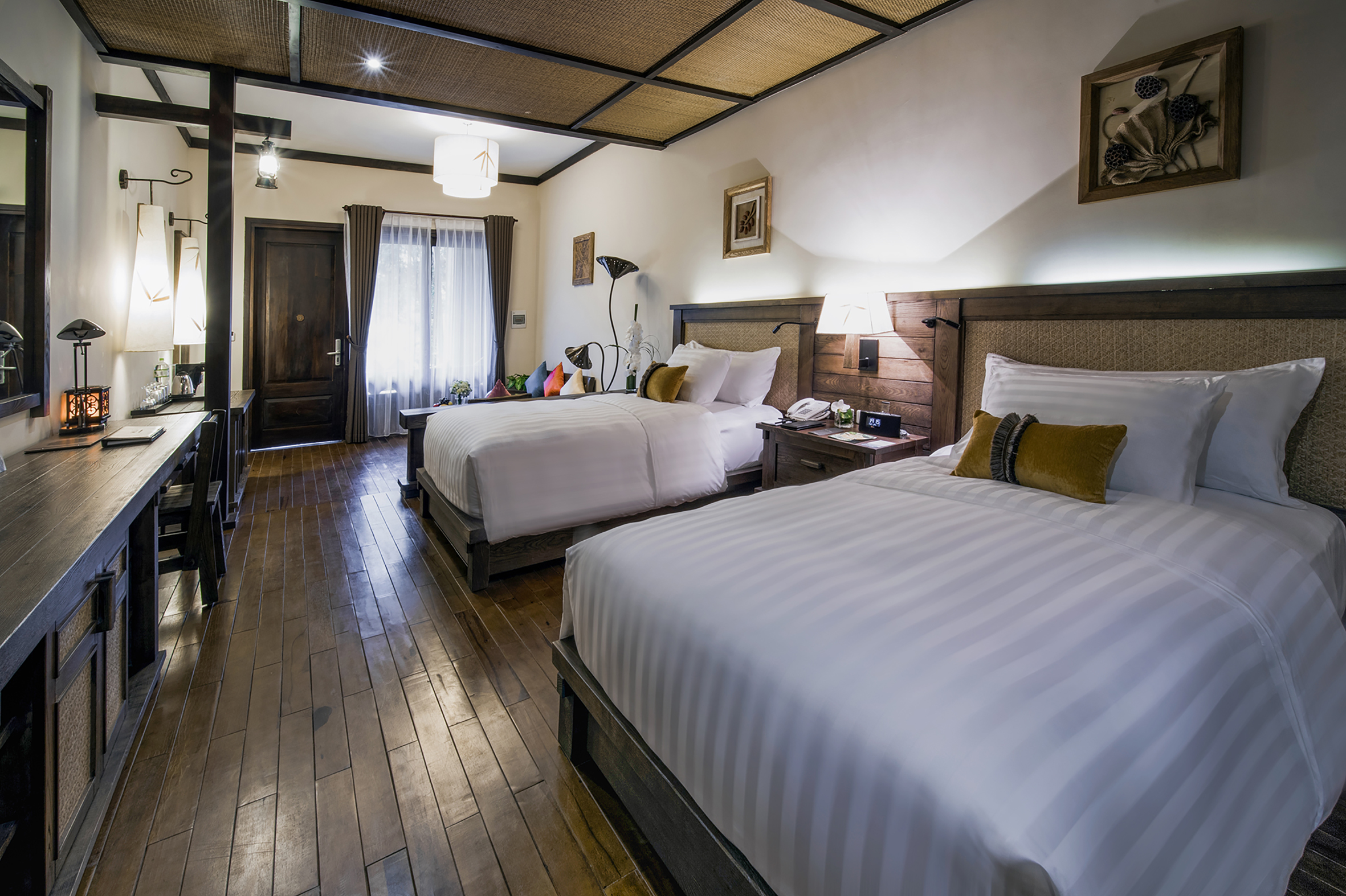 a room with two beds and a wood floor
