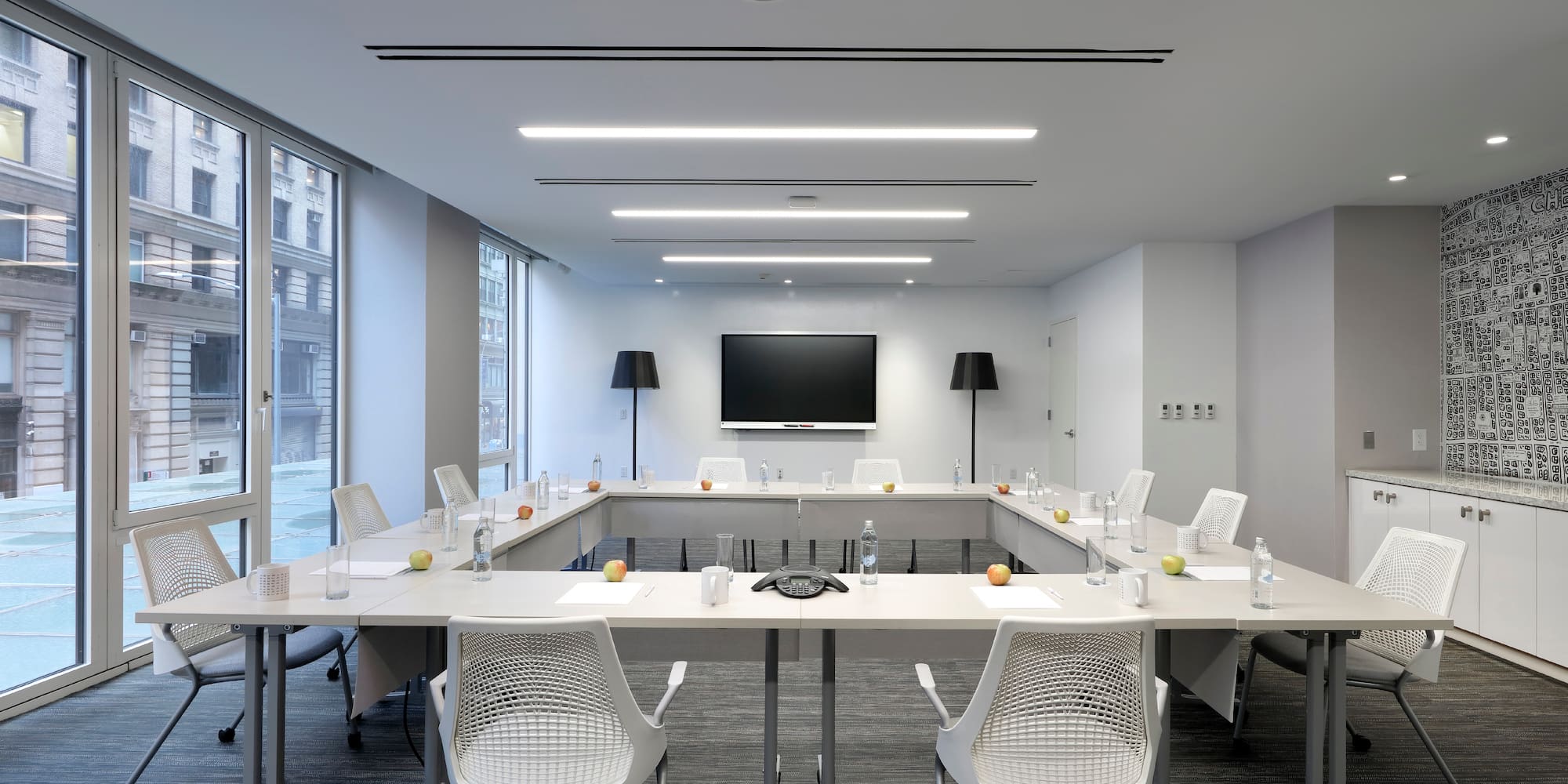 a conference room with white tables and chairs