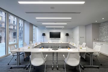 a conference room with white tables and chairs