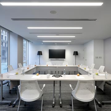 a conference room with white tables and chairs