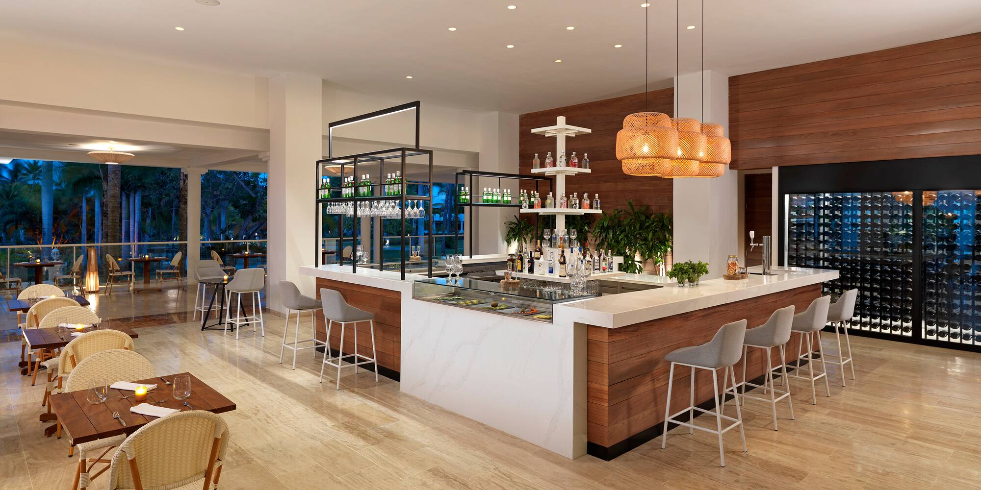 a room with a bar and chairs