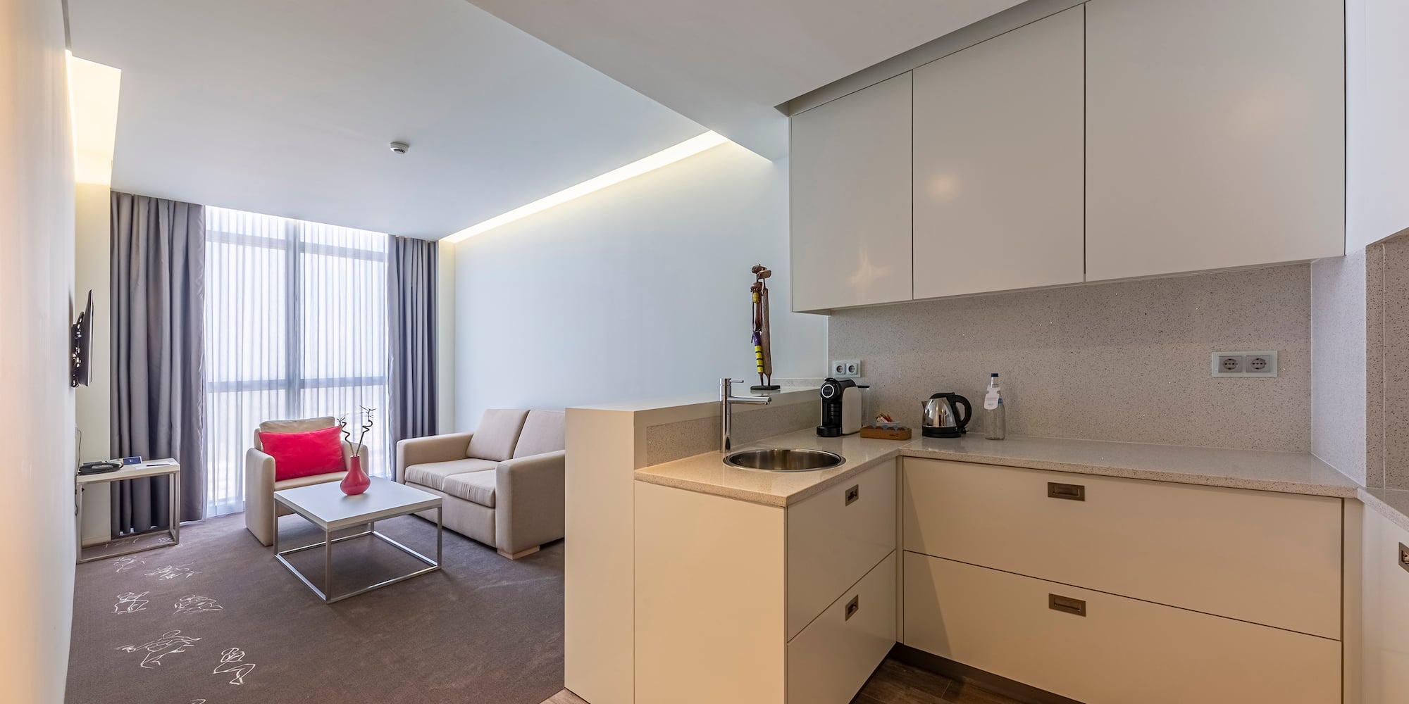 a room with a kitchen and a couch