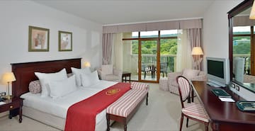 a hotel room with a bed and chairs