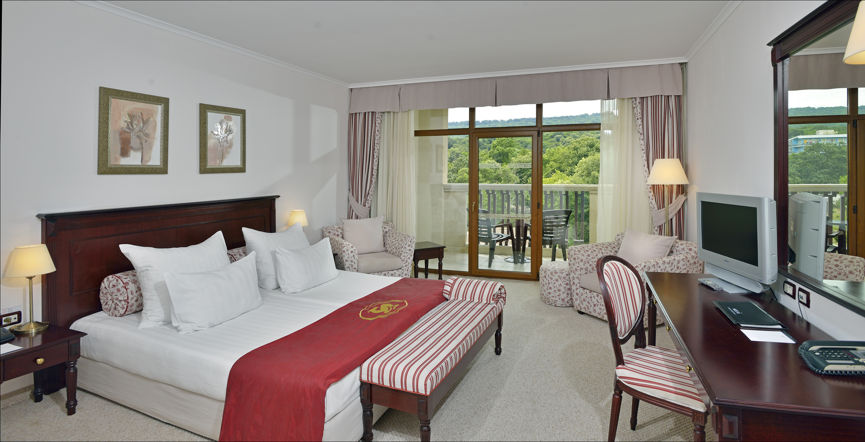 a hotel room with a bed and chairs
