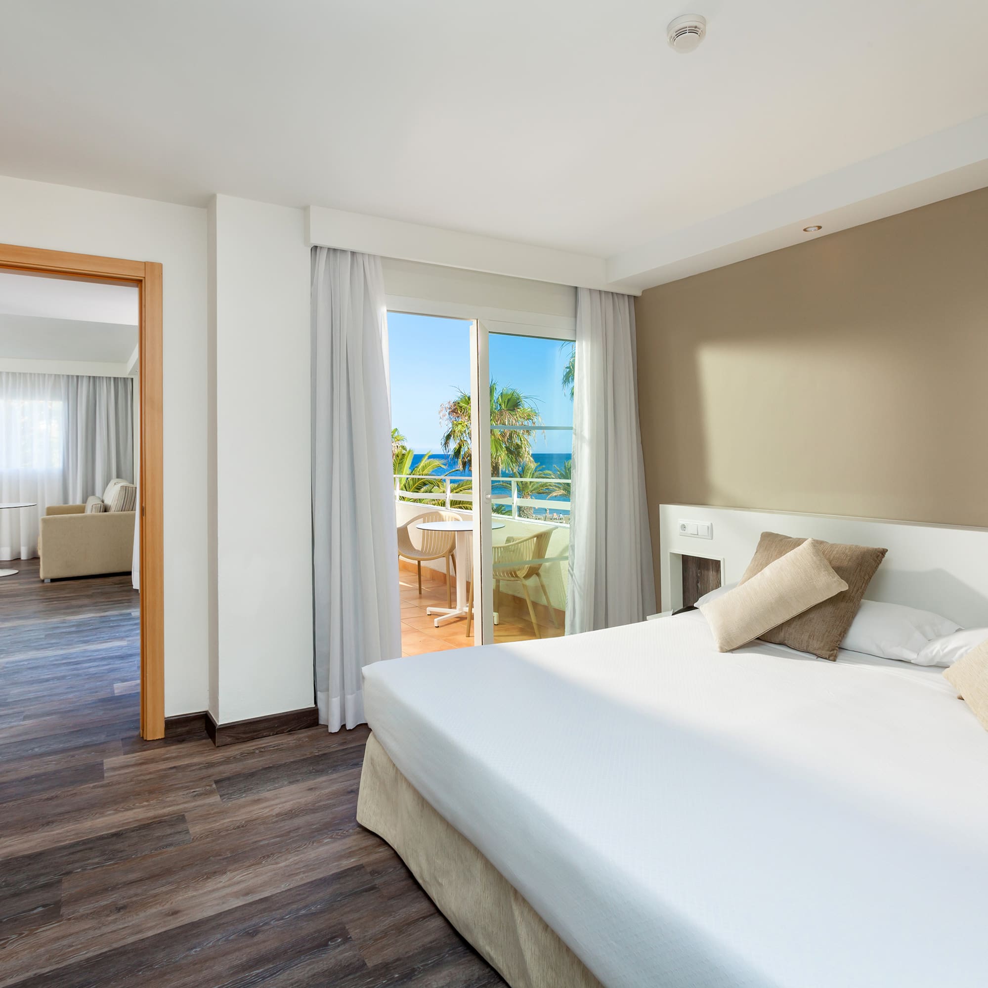 a bedroom with a door open to a balcony