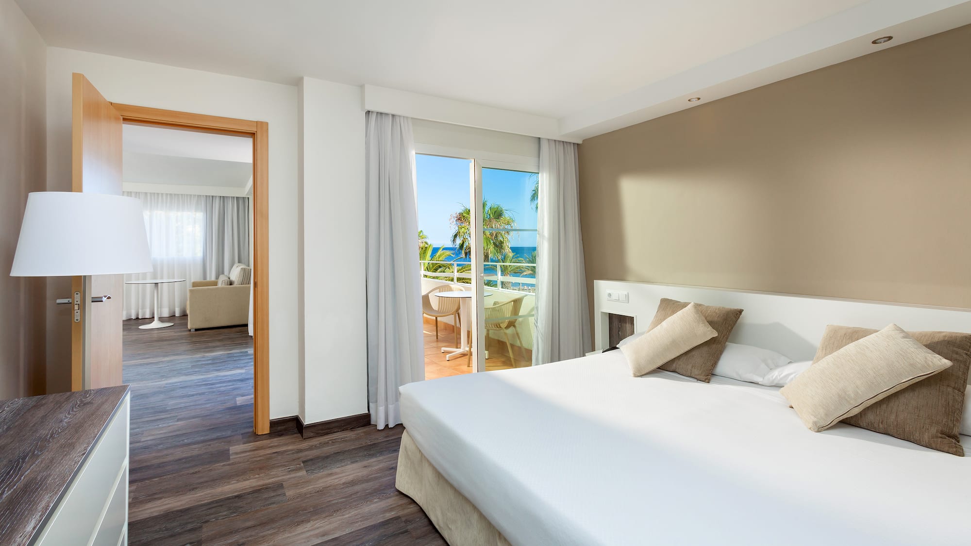 a bedroom with a door open to a balcony