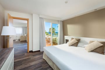 a bedroom with a door open to a balcony