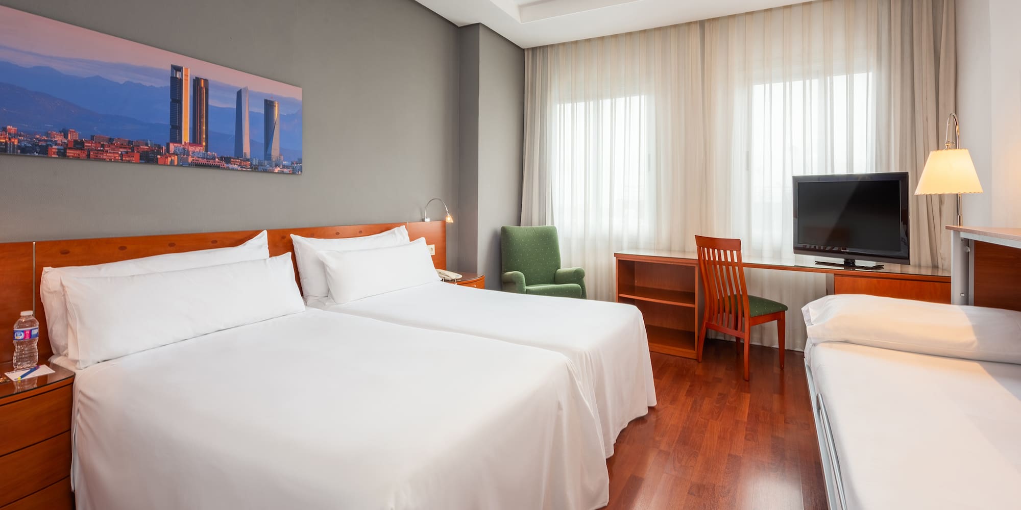 a room with two beds and a desk