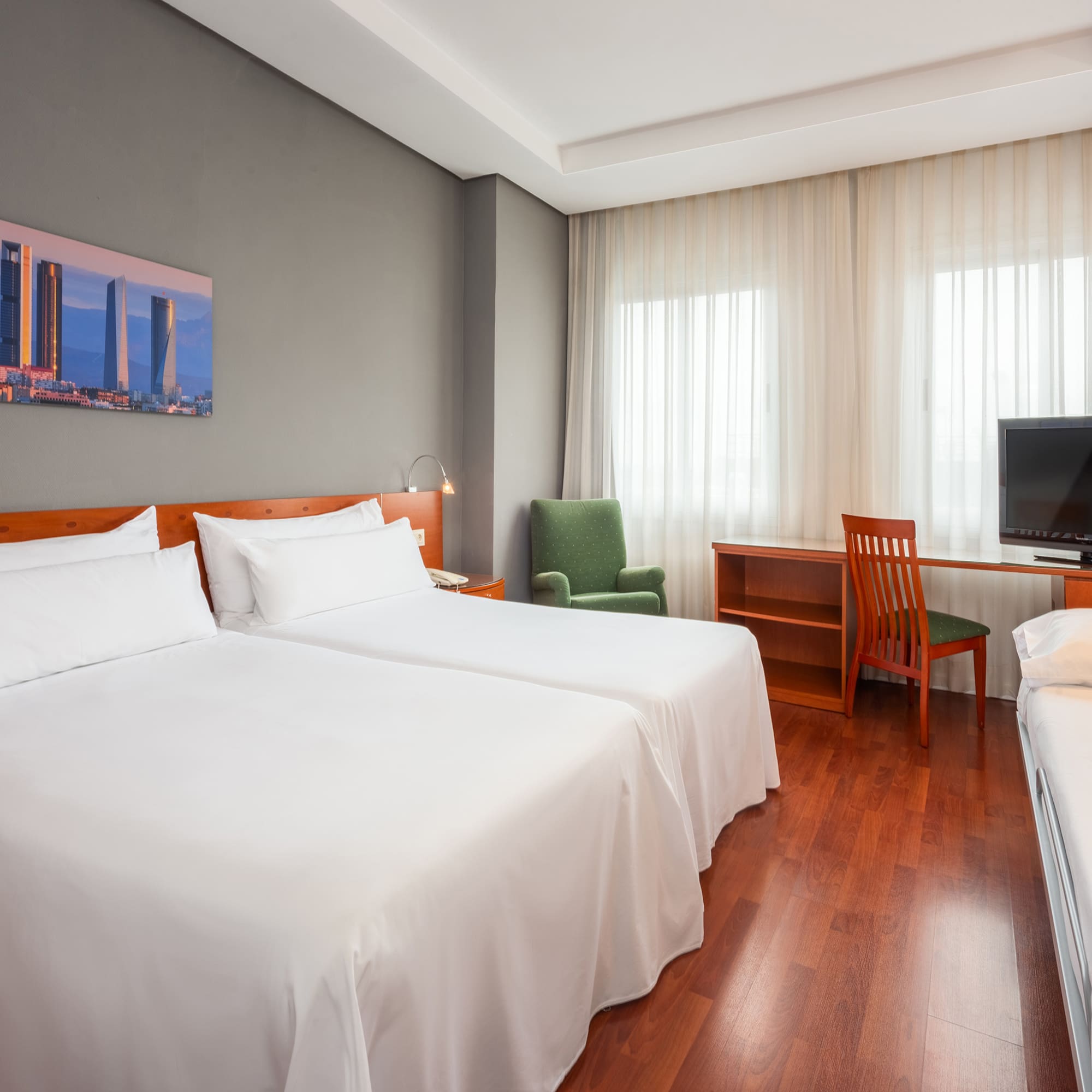 a room with two beds and a desk