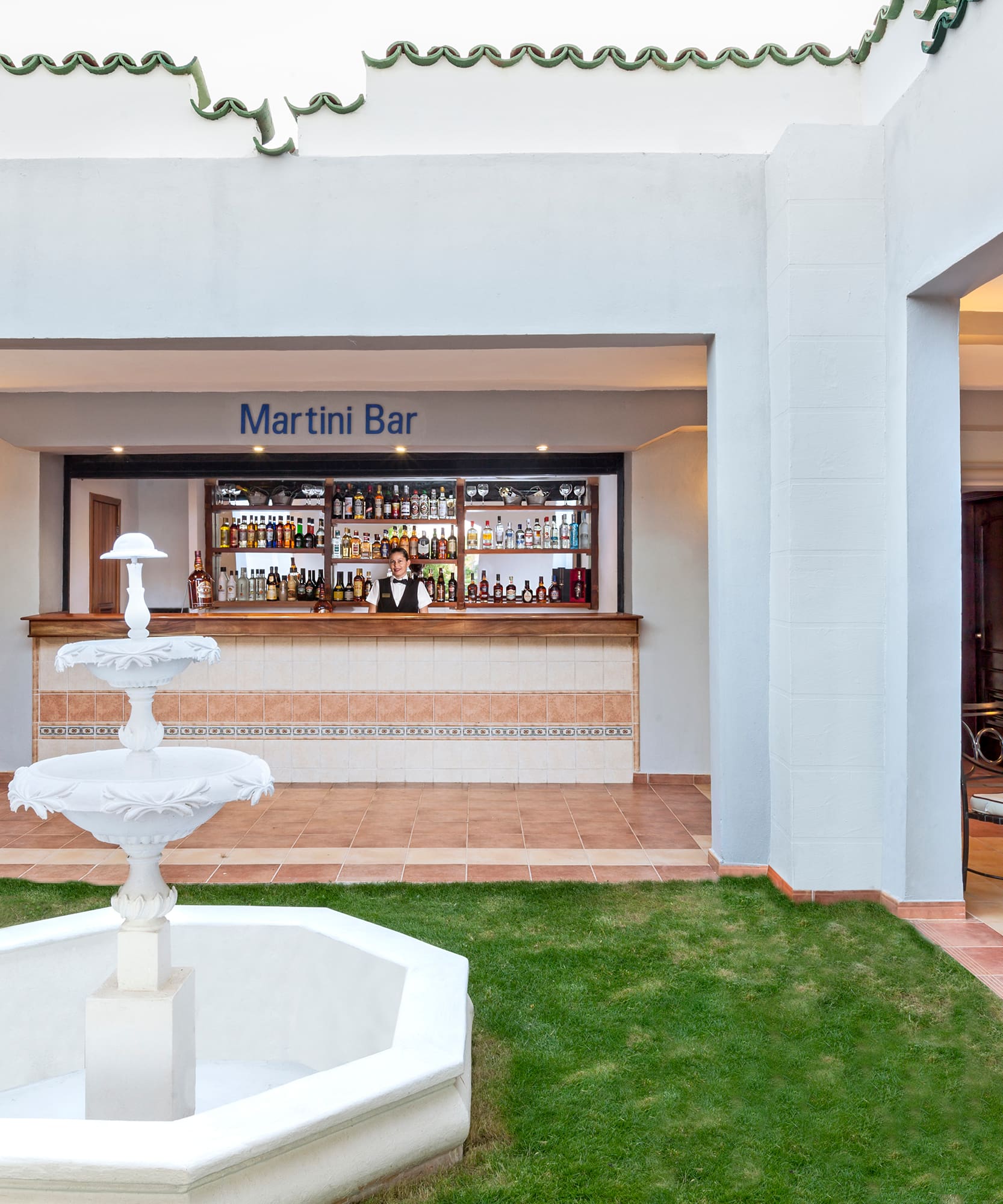 a fountain in front of a bar