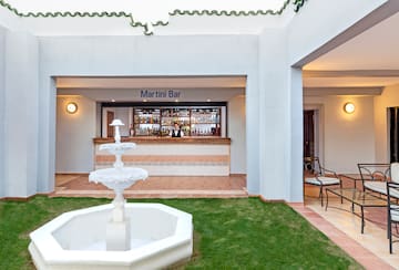 a fountain in front of a bar